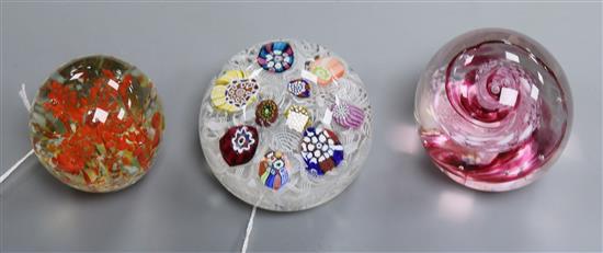 A Baccarat-style scattered millefiore glass paperweight on tumbled latticino ground and two other paperweights